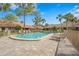 Community pool featuring beautiful clear water, poolside seating, and well-maintained deck under a clear blue sky at 3375 Sandleheath # 34, Sarasota, FL 34235