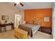 Bright bedroom with orange accent wall and a comfortable sitting area at 3410 Avenida Madera # B, Bradenton, FL 34210