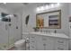 Modern bathroom with a white vanity, large mirror, and walk-in shower at 3410 Avenida Madera # B, Bradenton, FL 34210