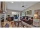 Elegant living room with a fireplace, built-in shelving, and leather furniture at 3410 Avenida Madera # B, Bradenton, FL 34210