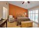 Spacious bedroom with orange accent wall and plenty of natural light at 3410 Avenida Madera # B, Bradenton, FL 34210