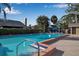 Inviting community pool with surrounding lounge chairs and shade structure at 3410 Avenida Madera # B, Bradenton, FL 34210