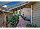 Brick pathway lined with lush greenery, leading to the home's entrance at 3410 Avenida Madera # B, Bradenton, FL 34210