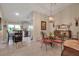 Charming dining room with glass-top table and four chairs, view to kitchen at 3410 Avenida Madera # B, Bradenton, FL 34210