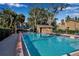 Community pool with patio furniture and shaded seating area at 3410 Avenida Madera # B, Bradenton, FL 34210