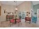 Bright dining area with a glass table and four coral chairs, access to private patio at 3410 Avenida Madera # B, Bradenton, FL 34210