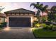 Single-story home with brown garage door, landscaping, and brick paver driveway at sunset at 4713 Stafford Ct, Palmetto, FL 34221