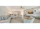 Open concept living room with light colored couches, hardwood floors and modern decor at 535 Sanctuary Dr # C807, Longboat Key, FL 34228