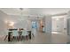 Elegant dining room with modern light wood table and six white chairs at 535 Sanctuary Dr # C807, Longboat Key, FL 34228