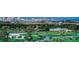 Aerial view of a golf course with city skyline in the background at 535 Sanctuary Dr # C807, Longboat Key, FL 34228