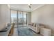 Serene home office featuring a comfortable sofa and balcony access at 535 Sanctuary Dr # C807, Longboat Key, FL 34228