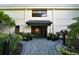 Attractive building entrance with landscaping and a paved walkway at 535 Sanctuary Dr # C807, Longboat Key, FL 34228