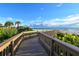Wooden boardwalk leads to beach with ocean view at 535 Sanctuary Dr # C807, Longboat Key, FL 34228