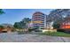 Luxury condo building with a brick driveway and landscaping at 535 Sanctuary Dr # C807, Longboat Key, FL 34228