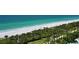 Aerial view of beach, lush landscape, and boardwalk at 535 Sanctuary Dr # C807, Longboat Key, FL 34228