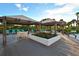 Spacious pool deck with covered seating and lounge chairs at 535 Sanctuary Dr # C807, Longboat Key, FL 34228