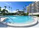 Relaxing pool area with steps and surrounding landscaping at 535 Sanctuary Dr # C807, Longboat Key, FL 34228