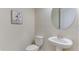Small powder room with pedestal sink and round mirror at 5431 Taliaferro Ct, Palmetto, FL 34221