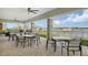 Covered patio with comfortable seating overlooking a lake at 5431 Taliaferro Ct, Palmetto, FL 34221