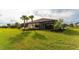 Charming home with a spacious backyard, lush landscaping, and screened patio at 5431 Taliaferro Ct, Palmetto, FL 34221