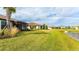 Lakefront backyard with lush grass and homes at 5431 Taliaferro Ct, Palmetto, FL 34221