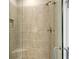 Walk in shower with neutral tile and built in seat at 5431 Taliaferro Ct, Palmetto, FL 34221