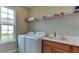 Laundry room with washer, dryer, and shelving at 5431 Taliaferro Ct, Palmetto, FL 34221
