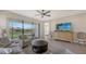 Open living room with access to patio and adjacent bedroom at 5431 Taliaferro Ct, Palmetto, FL 34221