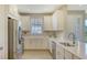 Modern kitchen with stainless steel appliances and white cabinetry at 5431 Taliaferro Ct, Palmetto, FL 34221