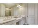 Double vanity bathroom with large mirror and shower at 5431 Taliaferro Ct, Palmetto, FL 34221