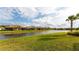 Backyard oasis with lake view and lush landscaping at 5431 Taliaferro Ct, Palmetto, FL 34221