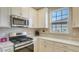 Stainless steel appliances and white cabinetry in this kitchen at 5431 Taliaferro Ct, Palmetto, FL 34221