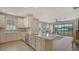 Modern kitchen with white cabinets, stainless steel appliances, and breakfast bar at 5431 Taliaferro Ct, Palmetto, FL 34221