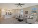 Living room with open kitchen, neutral colors, and tile flooring at 5431 Taliaferro Ct, Palmetto, FL 34221