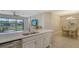 Island kitchen open to dining area with breakfast bar at 5431 Taliaferro Ct, Palmetto, FL 34221