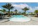 Relaxing pool area with palm trees and lounge chairs at 5431 Taliaferro Ct, Palmetto, FL 34221
