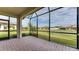 Screened patio with brick pavers overlooking a tranquil backyard at 5431 Taliaferro Ct, Palmetto, FL 34221