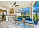 Outdoor kitchen with stainless steel appliances and seating area at 6249 Mesa Gln, Bradenton, FL 34203