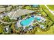 Aerial view of community pool, clubhouse, and surrounding landscape at 6249 Mesa Gln, Bradenton, FL 34203