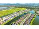 Aerial view of community with lakefront homes and lush green spaces at 6249 Mesa Gln, Bradenton, FL 34203