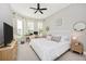 Spacious bedroom with large windows, a king-size bed, and a built-in workspace at 6249 Mesa Gln, Bradenton, FL 34203