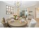Open concept dining area with oval table, neutral decor, and views into adjacent rooms at 6249 Mesa Gln, Bradenton, FL 34203