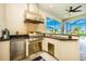 Stainless steel outdoor kitchen with grill and bar seating at 6249 Mesa Gln, Bradenton, FL 34203