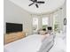 Bright bedroom featuring a king-size bed, ample natural light, and a work area at 6249 Mesa Gln, Bradenton, FL 34203