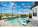 Screened pool and patio with comfortable lounge chairs and lake view at 6249 Mesa Gln, Bradenton, FL 34203