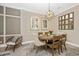 Elegant dining room featuring a wood table and chairs, stylish light fixture, and neutral decor at 6249 Mesa Gln, Bradenton, FL 34203