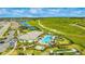 Aerial view of community with pool, tennis courts, and open green space at 6249 Mesa Gln, Bradenton, FL 34203