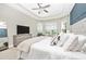Main bedroom with large bed, TV, and plenty of natural light at 6249 Mesa Gln, Bradenton, FL 34203