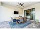 Covered patio with dining area, glass doors, and ceiling fan at 6249 Mesa Gln, Bradenton, FL 34203