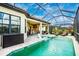 Inviting pool and patio with screened enclosure and lounge chairs at 6249 Mesa Gln, Bradenton, FL 34203